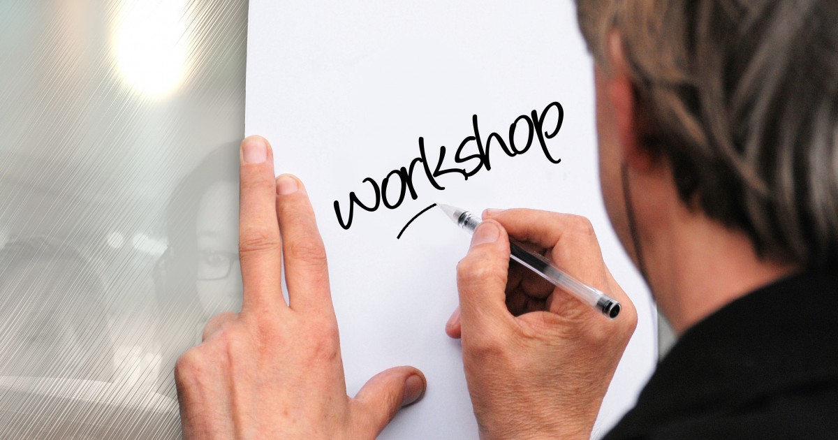 Man writing workshop on a piece of paper in black marker