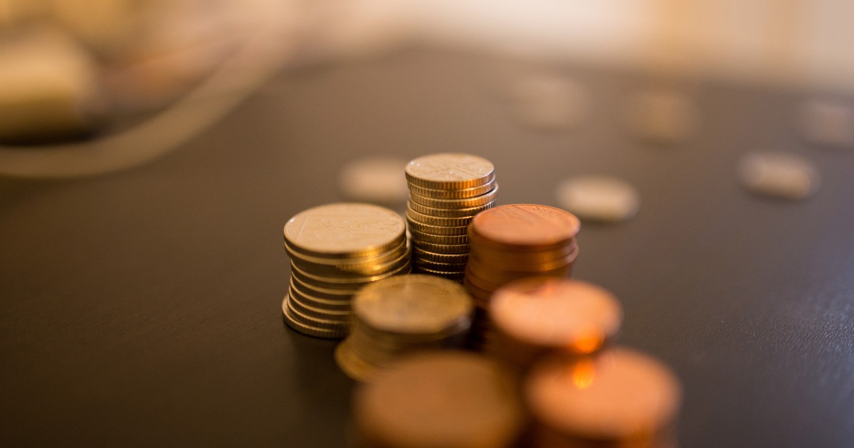 Stack of coins on desk with blur effect